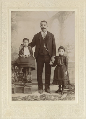 Hombre con niñas en un estudio fotográfico, retrato