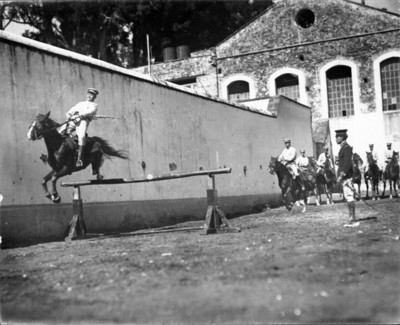 Militares a caballo realizan practicas con obstáculos