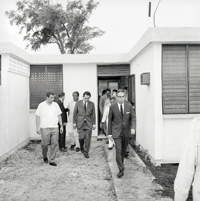 Gustavo Díaz Ordaz y comitiva salen de una casa