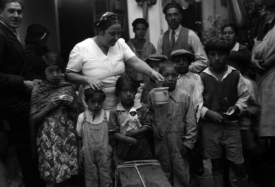 Niños acompañados de adultos en un patio