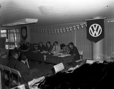 Ejecutivos en mesa directiva durante convención de empresa volkswagen