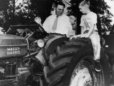 Hombres y niño abordo de un tractor