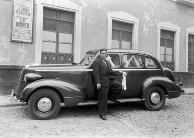 Hombre junto a un automóvil estacionado