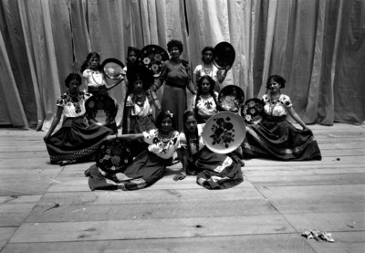 Niñas con vestuario teatral, y su maestra, durante un festival