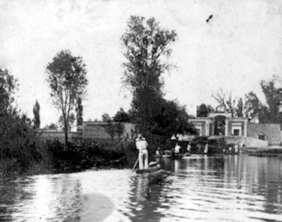 Hombres en trajineras por el canal