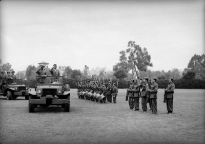Miguel Alemán Valdés rindiendo honores a la bandera en un campo del Colegio Militar